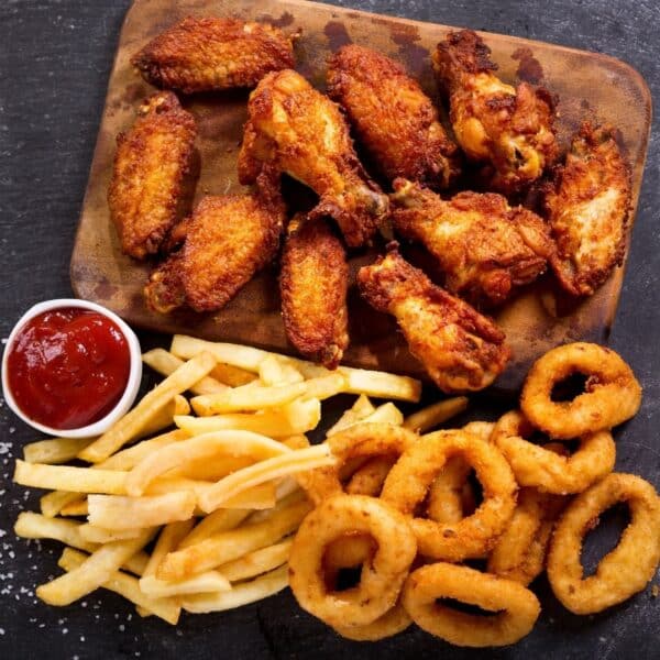 Fried foods: chicken wings, french fries, and onion rings.